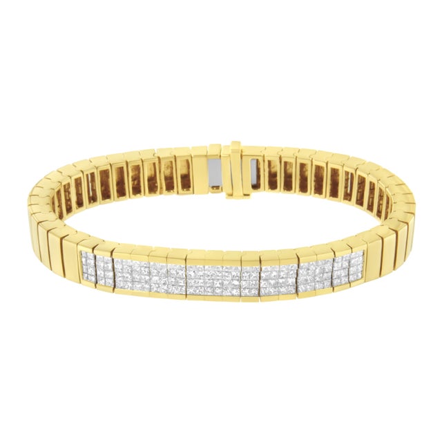 This beautiful bracelet is made in 14k yellow gold and it's inlaid with 3 5/8ct TDW of invisible set princess cut...