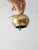 A charming vintage mid-century brass bell cast in the form of an apple, with a softly aged finish and finely articulated...