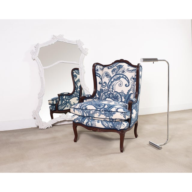 Fantastic French country provincial or Louis XV style wingback bergere á Oreilles featuring a dramatic blue and white...