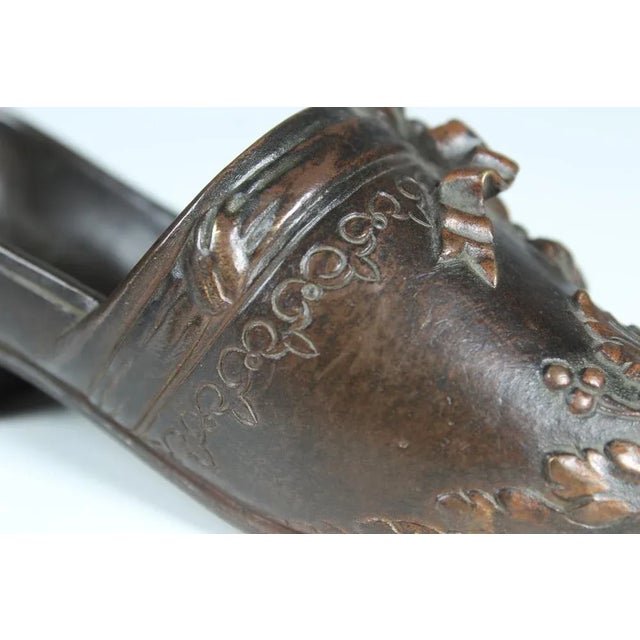 Antique bronze sculpture, depicting a French lady's shoe from the 19th century. Very nice detailed elaboration of the bows...