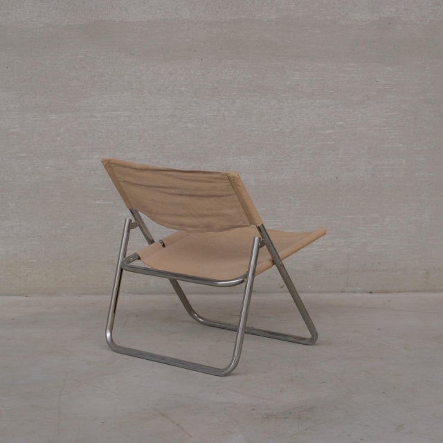 An original mid-century chrome and linen lounge chair. Sweden, c1970s. By Niels Gammelgaard. 'Cox' model. Good condition,...