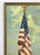 Vintage oil on board of the American Flag on pole with eagle, village buildings at bottom. Painting is signed "Bucy"...