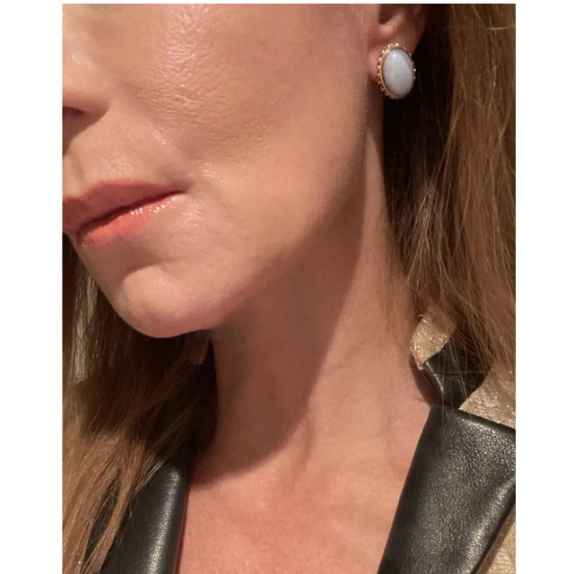 A chic pair of vintage oval chalcedony quartz and 14-karat yellow gold earrings, circa mid-20th century. Chalcedony is...