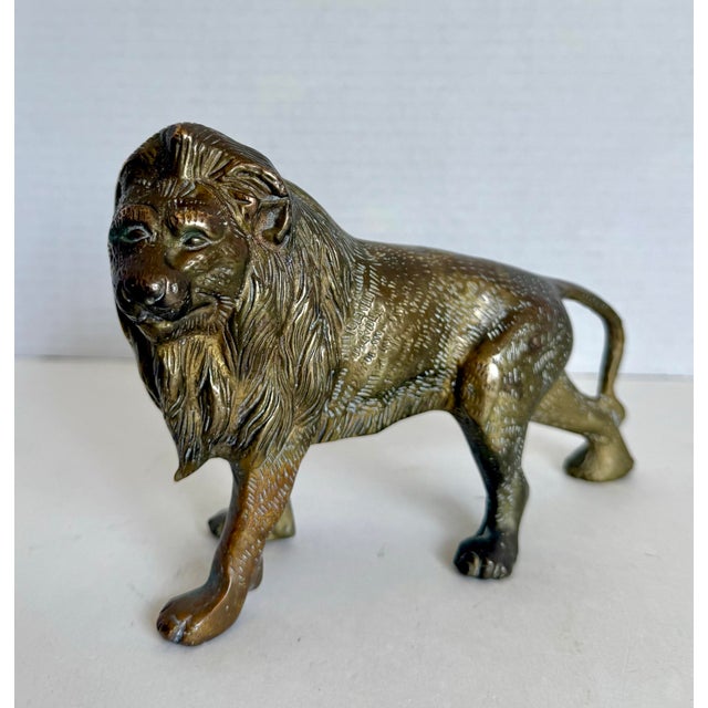 Here is a wonderful vintage solid brass lion figurine, likely made in the mid-20th century. This piece has a wonderfully...