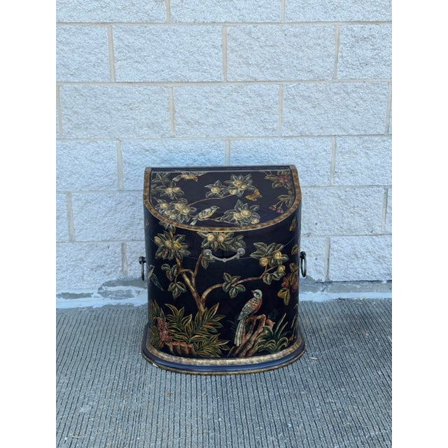 Chinoiserie-style storage cabinet with a rounded front and lift-top lid. Black ground with decorative surface detailing...