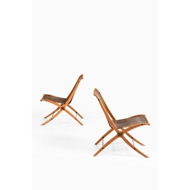 This rare pair of easy chairs, model fh-6135—commonly referred to as the x-chair—was designed by peter hvidt and orla...