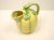 A vintage Majolica style ceramic pitcher in the shape of a cantaloupe melon. No maker's mark on the bottom. Hand wash only.