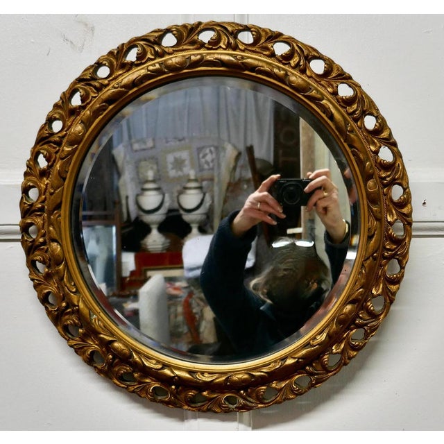 Carved bevelled gilt round wall mirror This is a very attractive mirror has a 3” wide gilt frame which is carved and...