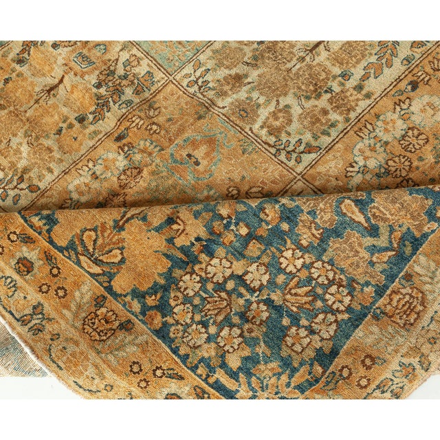 A late 19th century antique Tabriz rug from Northwest Persia with an allover rectangular panel design in light blue, ivory...