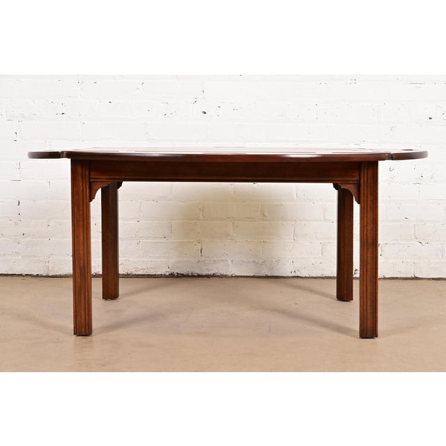 A gorgeous Chippendale style butler's coffee table with removable tray top By Baker Furniture USA, Circa 1980s Book-...