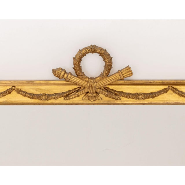 Louis XVI Style Giltwood Framed Mirror, with wreath and torch crest and garland motif. Mirror plate: 25" H x 45.25" W;...