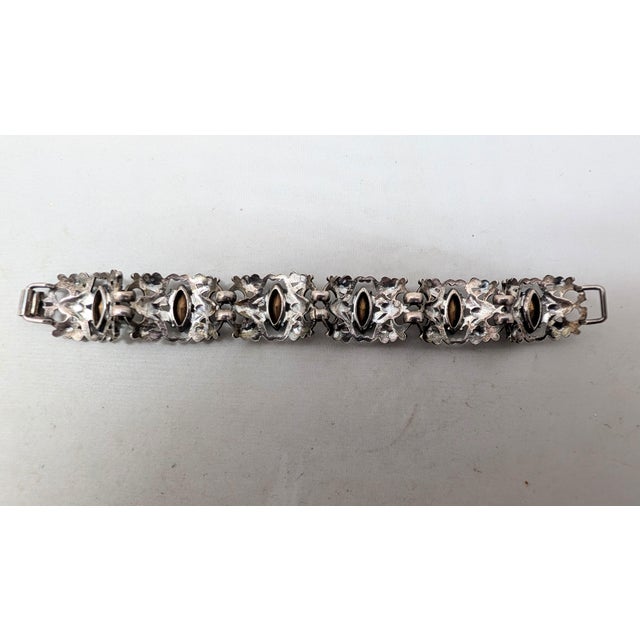 Late 1940s to early 1950s art nouveaux style silvertone with marquise faux-aquamarine link bracelet with fold over clasp....