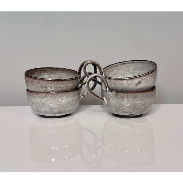 An impressive set of four studio ceramic art tea cups, created by the renown ceramist duo Elli and Walter Serocka, whose...