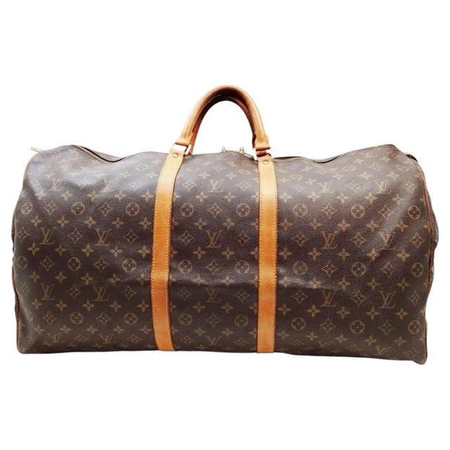 This authentic Louis Vuitton Keepall Boston Bag is a timeless travel essential featuring the iconic brown monogram coated...