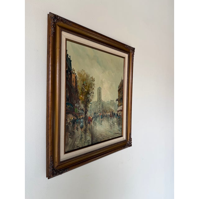 A captivating 1960s Impressionist oil on canvas painting depicting a bustling Parisian boulevard on a rainy afternoon....