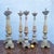 Set of six large candlesticks or candelabra, carved from wood lacquered in cream and gilt. Placed on the floor or on...