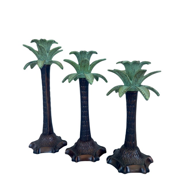 A set of three graduated, weighted bronze candle holders (candlesticks) with lovely green palm fronds/leaves. Lots of...
