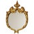 A beautiful, classic Baroque-style mirror gilded with gold leaf; the ornate frame is crafted from resin and marked...