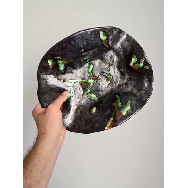 An elegant french art ceramic trinket dish or decorative platter with a free-flowing, undulating silhouette. This piece...