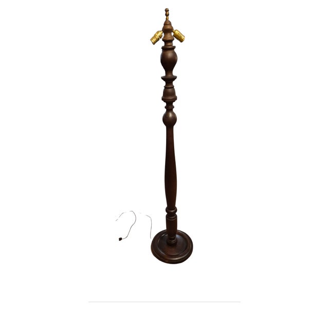 A goid looking wooden floor lamp stands 65.5 inches tall. The base is 13.5 inches in diameter..shade not included....