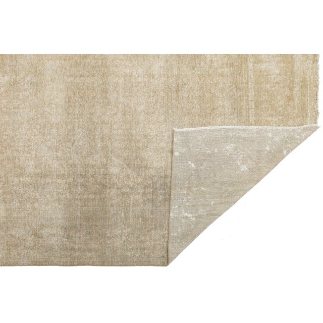 This Antique Tabriz Wool Rug is a stunning example of subtle luxury, featuring a unique moiré wave pattern that departs...