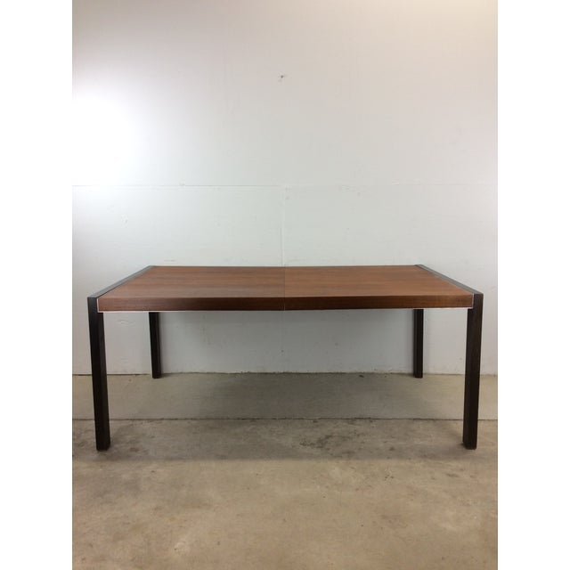 This mid century modern dining table by John Stuart features beautiful walnut top with original finish and four black...