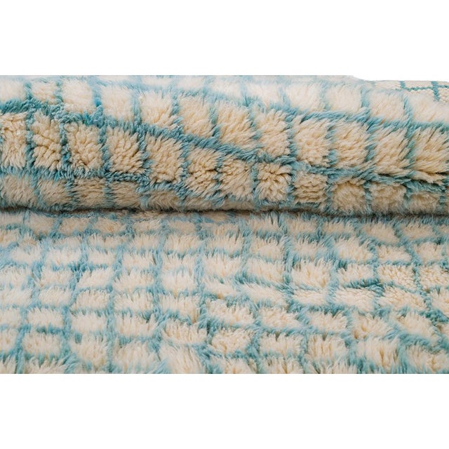 A fine mesh of blue, woven like morning mist. A delicate crosshatch of diamond lattice lines ripples across this piece in...
