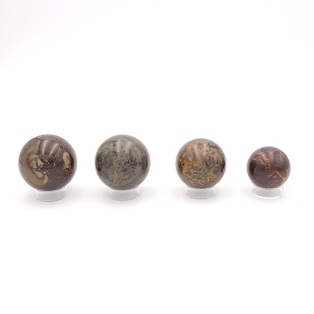 A set of four Japser stone spheres. The sizes range from 2.5" to 1.75" diameter.