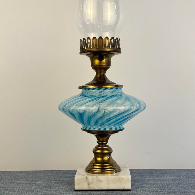 Vintage oil lamp with a gorgeous blue swirl glass font, brass accents and a marble base. Electrified with new wiring and...