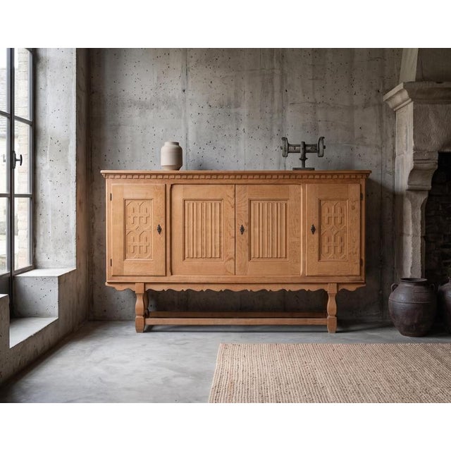 A beautiful and substantial oak sideboard designed by henning kjærnulf for eg møbler, denmark, dating from the late 1960s....