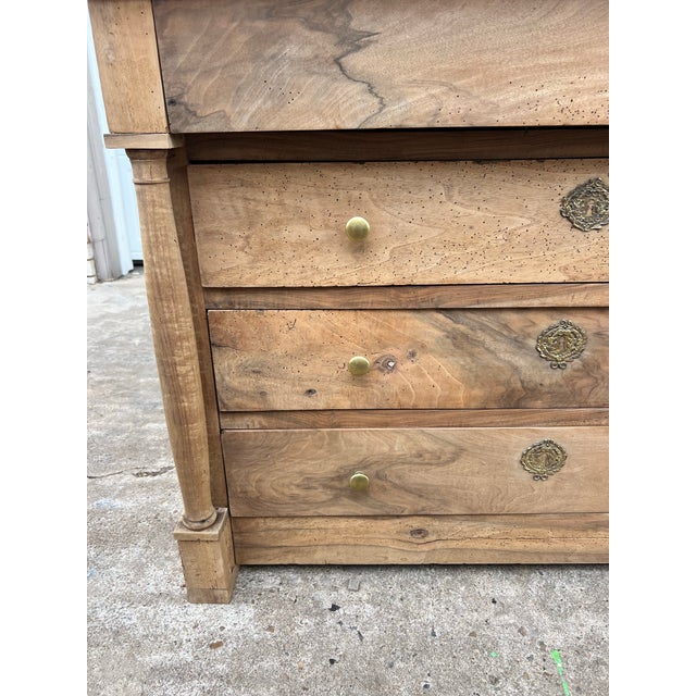 French 18th-century Empire-style bleached walnut commode, featuring a simple architectural form, three drawers, columnar...