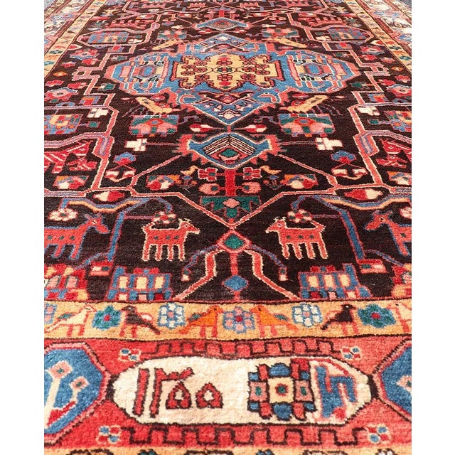 Measures: 4'3 x 9'4. This absolutely stunning Antique Nahavand (circa 1920s) features a symmetrical sub-geometric design...