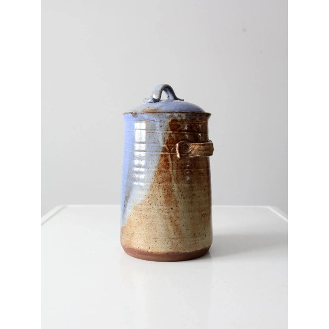 A vintage late 20th century studio pottery jar, hand-crafted and artist signed on the base. This art pottery canister has...