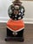 A vintage Maitland-Smith porcelain lamp featuring a richly contrasted black and pink base adorned with finely hand-painted...
