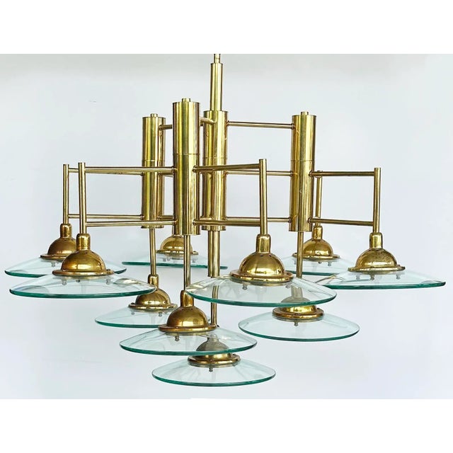 Vintage Modern Brass and Glass 10-Light Chandelier with Multiple Tiers Offered for sale is an unusual modern multi-tiered...