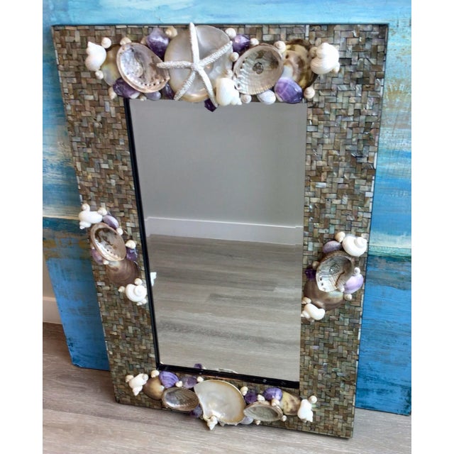 Black lip Shell mosaic frame festooned by a sophisticated array of shells in Silver purple white and amethyst rock...