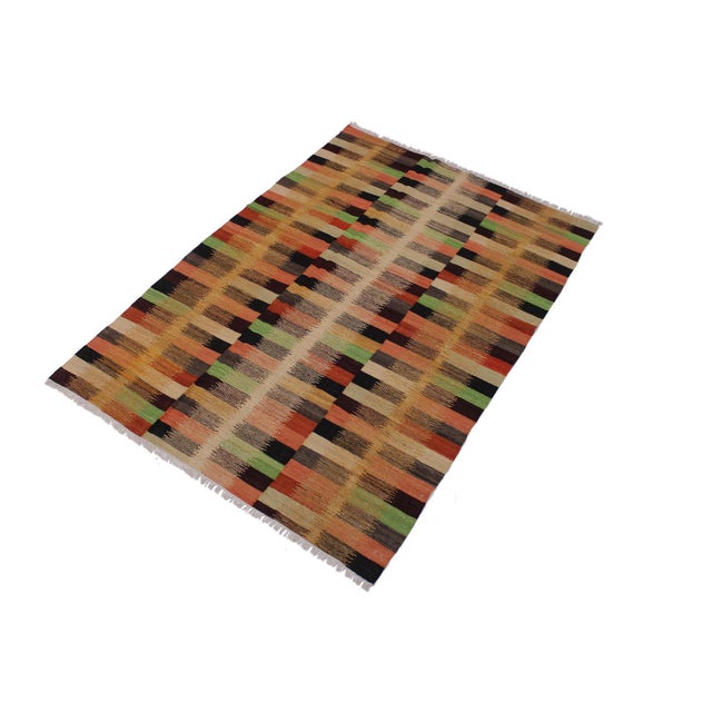Add a touch of elegance to your home with this casual chic hand woven Tribal Kilim wool rug. Constructed on a loom by...