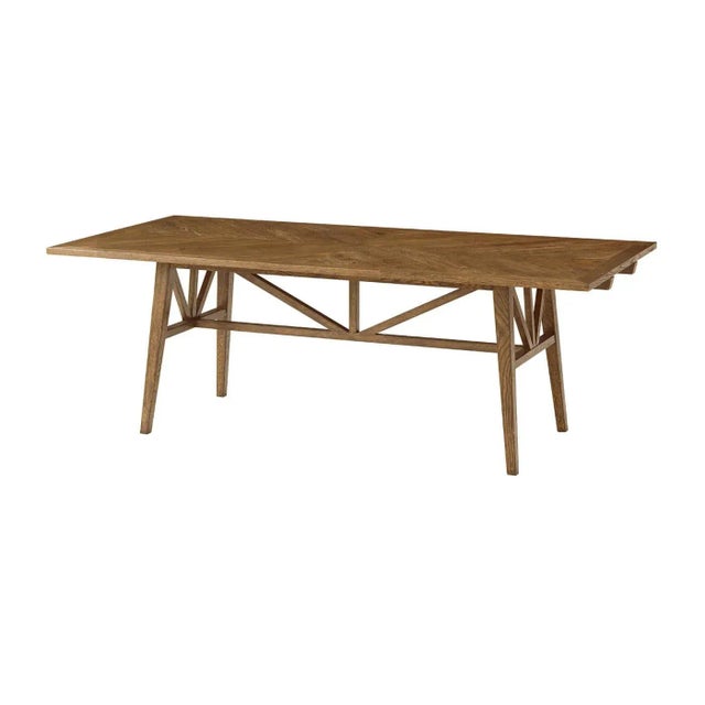 An oak parquetry extending dining table with finely tapered oak legs. This beautiful table is crafted from rustic oak with...