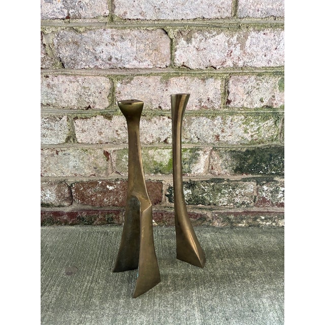 Pair of Mid-Century Modern solid brass candlesticks, Scandinavian. The candleholders feature a sculptural, organic shape,...