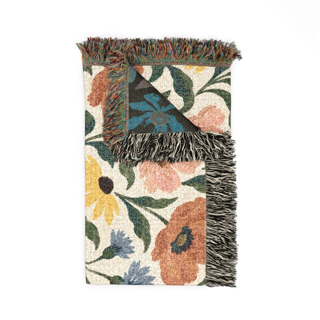 This English Country-style wildflower woven throw blanket features rust and blush blossoms, golden yellow daisies, and...