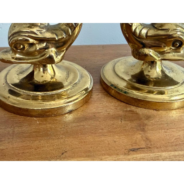 Late 20th century brass dolphin candlestick holder pair, attributed to Brighton, in a neoclassical mythology design....