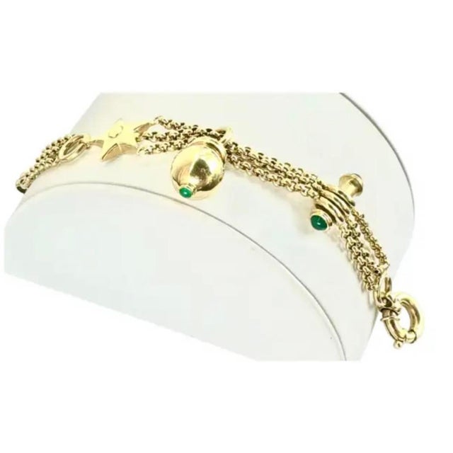 Vintage 14K Gold Italian Charm Bracelet with Three Charms. Crafted with three draped curb-link chains, the bracelet is...