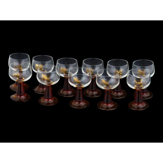A vintage French Roemer wine glasses set with a distinctive amber beehive shaped stem. The set includes eleven glasses....