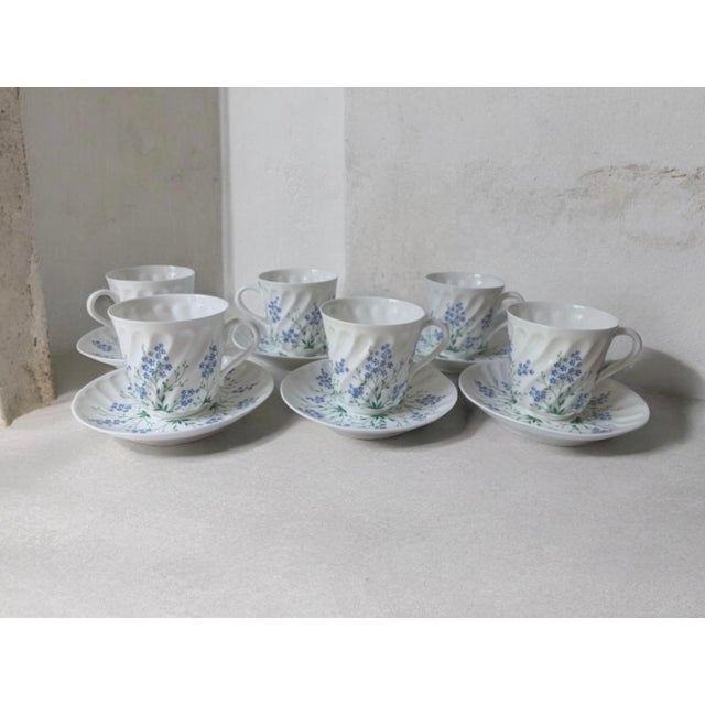 This is a Lomonosov Russian porcelain tea cup and saucer set, likely featuring the "Forget-Me-Not" pattern on a "Twisted"...