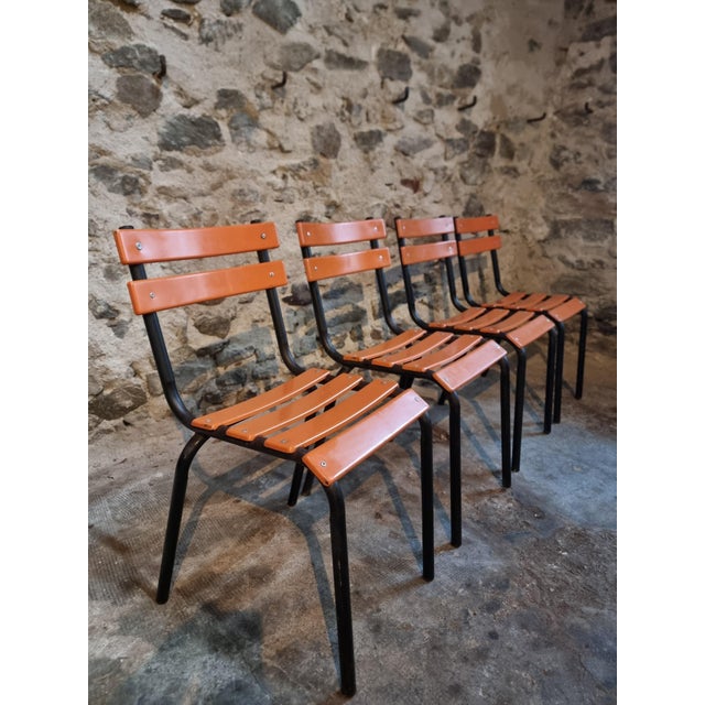 This set of four French industrial school chairs dates from the 1960s. The chairs feature a sturdy black tubular steel...