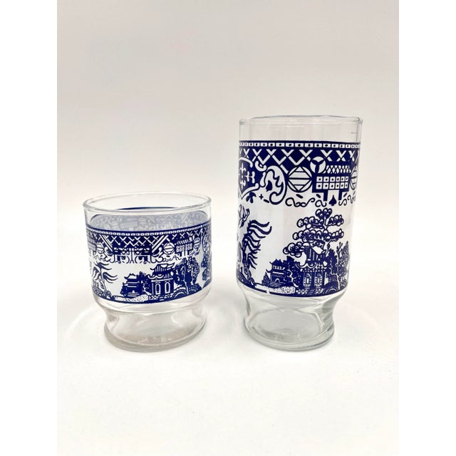 Fabulous find! A complete set of 16 Blue Willow barware glassware from the 1970s. The glasses feature the distinct blue...