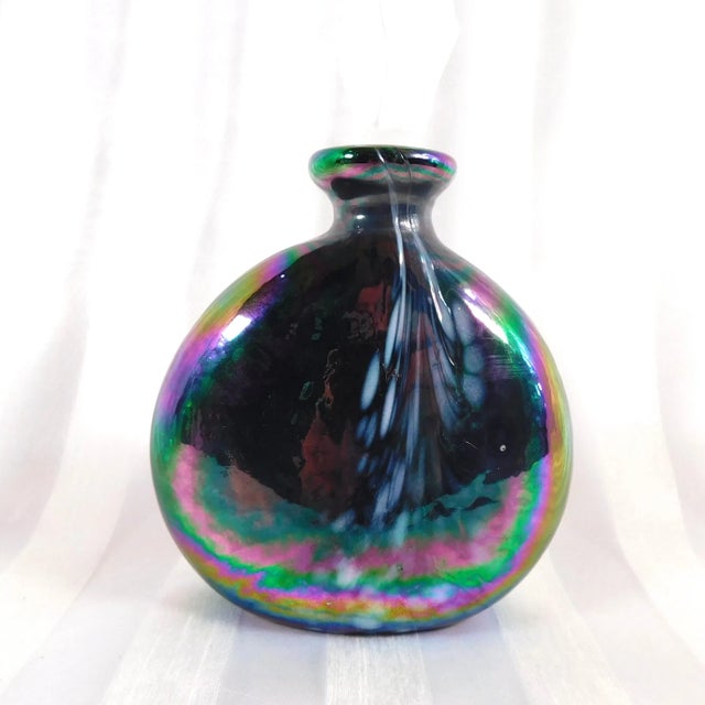 This is a round iridescent purple perfume bottle from Glass Act Studio of Taiwan. The bottle has a small frosted stopper...