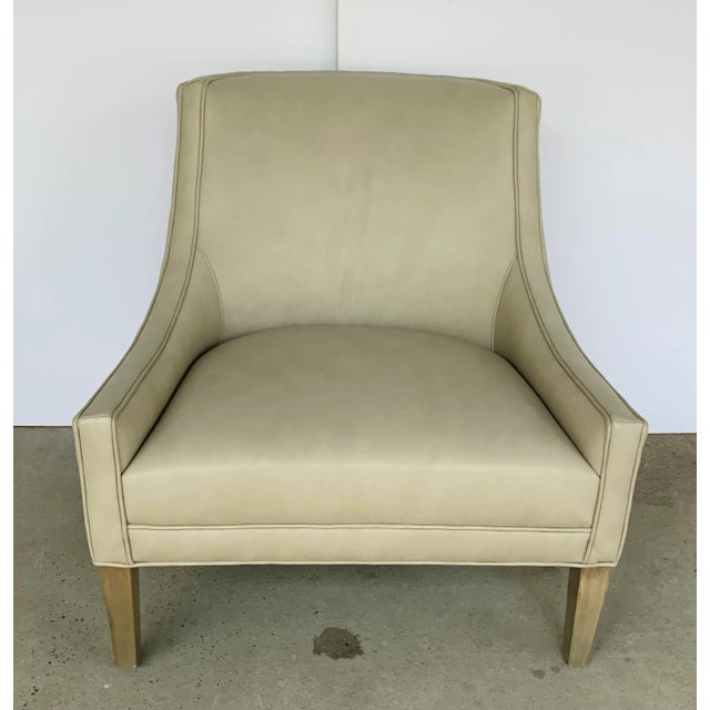 Timeless Modern beige Leather Club Chair, light wood legs, showroom floor sample