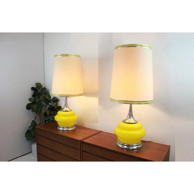 Take a look at this beautiful pair of lamps, the bodies are yellow glass and the base and necks are chrome. They are...