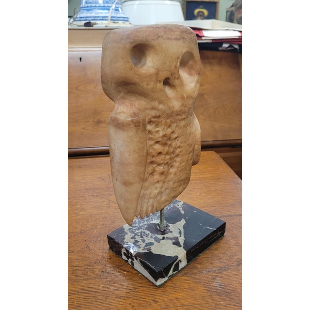 Mid-century modern carved marble or alabaster owl on a black marble base. Measuring 11 1/2 inches tall by 4x6 inches at...